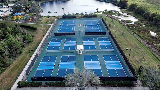 view of sport court with a water view