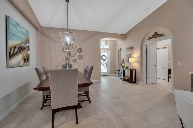 dining space featuring lofted ceiling and light tile patterned floors