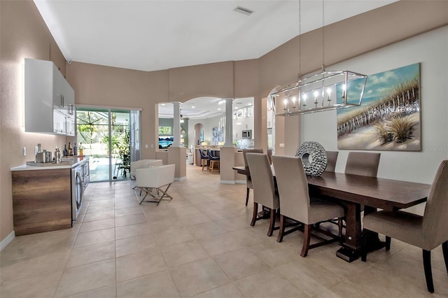 tiled dining space featuring decorative columns