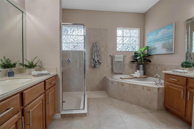 bathroom featuring tile patterned floors, separate shower and tub, and vanity