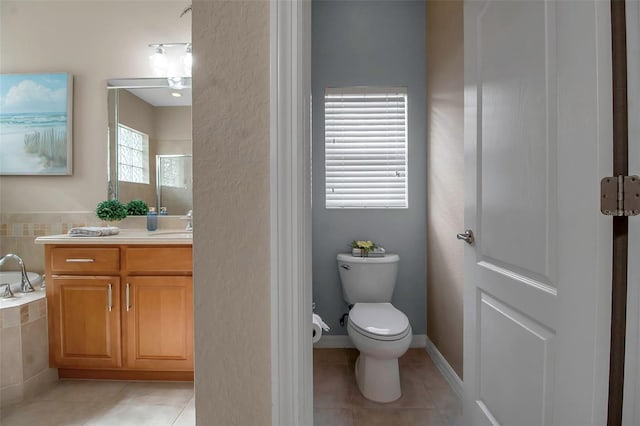 bathroom with tile patterned floors, vanity, and toilet