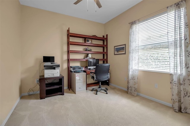 carpeted office featuring ceiling fan