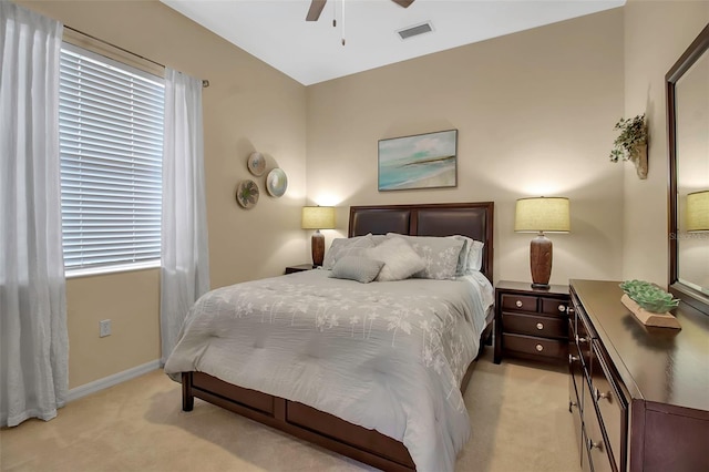 bedroom with ceiling fan and light carpet