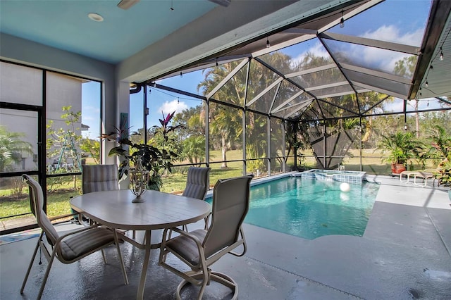 view of pool with glass enclosure and a patio area