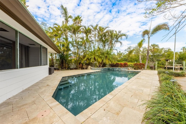 view of swimming pool with a patio area