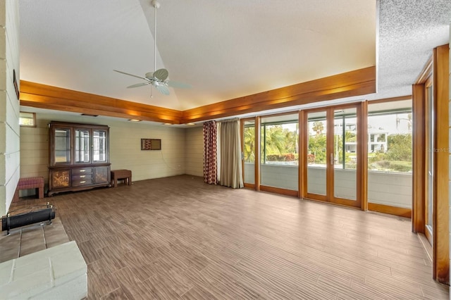 unfurnished living room with a textured ceiling and ceiling fan