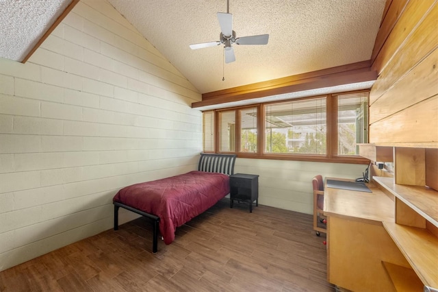 bedroom with ceiling fan, lofted ceiling, and hardwood / wood-style flooring