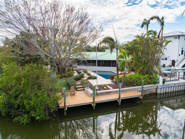 dock area with a water view and a patio