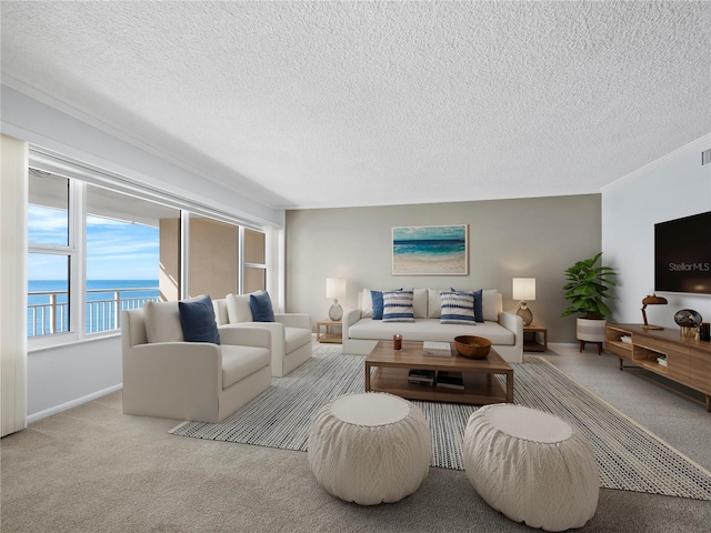 carpeted living room featuring a water view and a textured ceiling