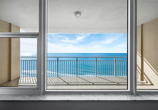 balcony featuring a water view and a view of the beach