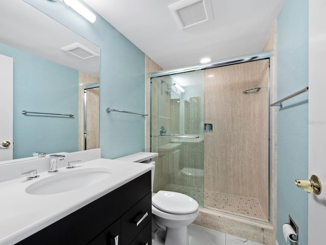 bathroom featuring tile patterned flooring, vanity, toilet, and a shower with door