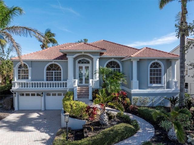 mediterranean / spanish-style house featuring french doors and a garage