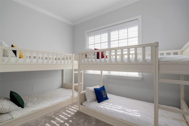 carpeted bedroom featuring multiple windows and crown molding