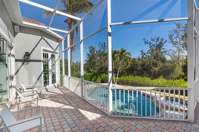 view of swimming pool featuring a lanai and a patio