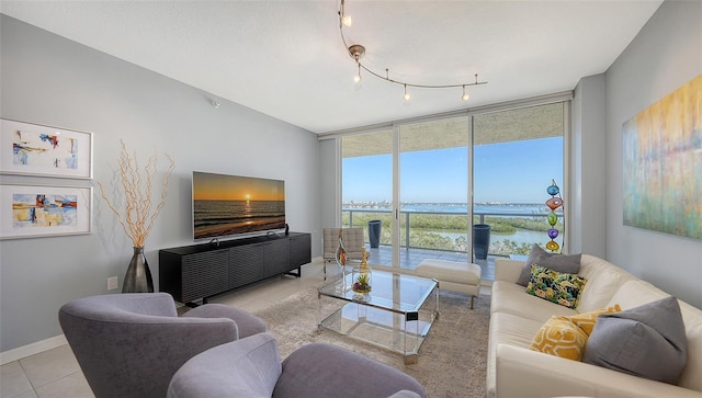 living room with light tile patterned floors and a wall of windows