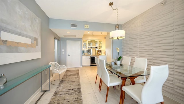 dining space with light tile patterned floors and beverage cooler