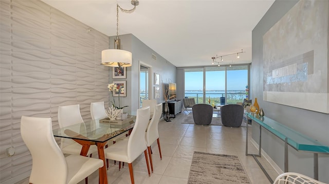 tiled dining area with expansive windows and track lighting