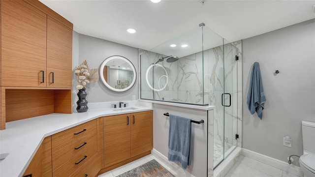 bathroom featuring toilet, vanity, a shower with door, and tile patterned floors