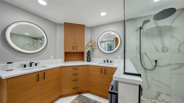 bathroom featuring tile patterned floors, a shower with door, and vanity