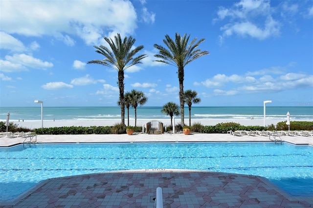 view of swimming pool featuring a water view