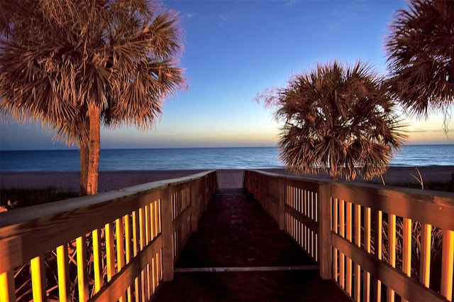 view of home's community featuring a water view and a beach view