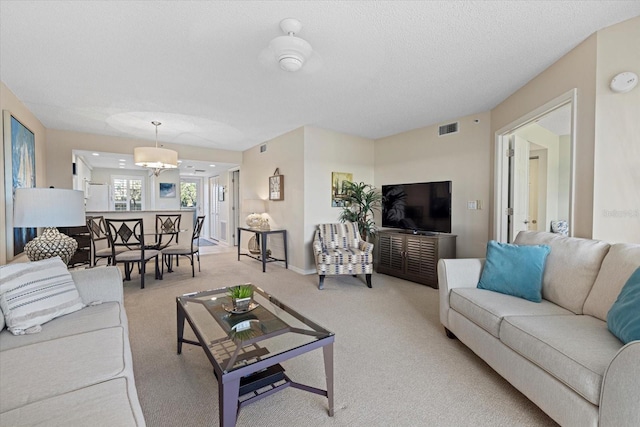 carpeted living room with a textured ceiling