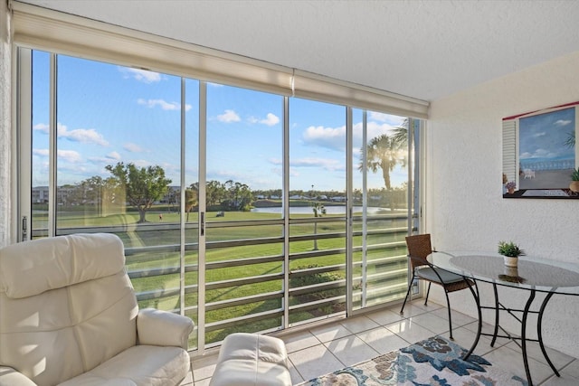 sunroom / solarium with a water view