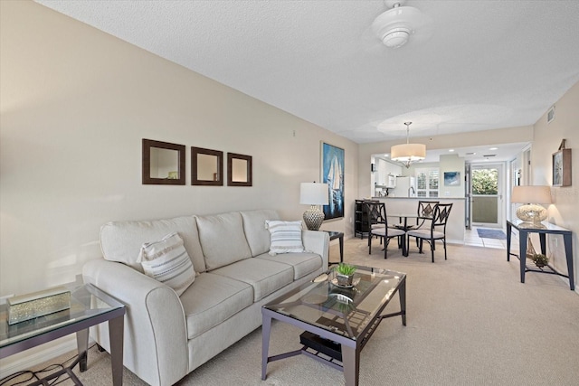 carpeted living room with a textured ceiling