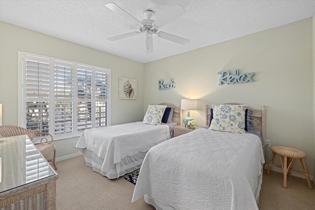 bedroom featuring light carpet, a textured ceiling, and ceiling fan