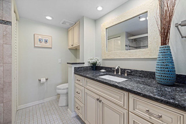 bathroom featuring tile patterned flooring, vanity, toilet, and a tile shower