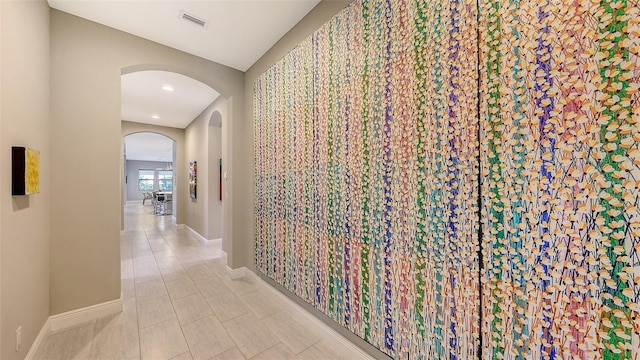 hall with light tile patterned flooring