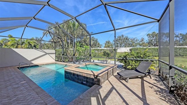 view of pool with a patio area, an in ground hot tub, and glass enclosure