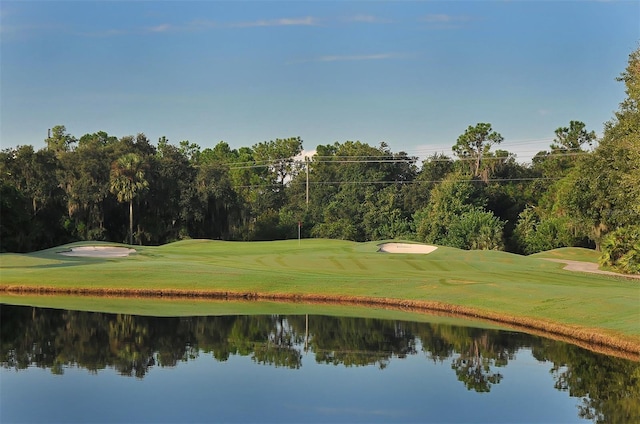 view of home's community featuring a yard and a water view