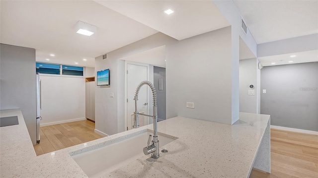 bathroom with hardwood / wood-style floors and sink