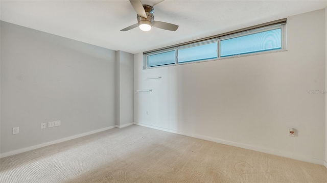 unfurnished room featuring light carpet and ceiling fan