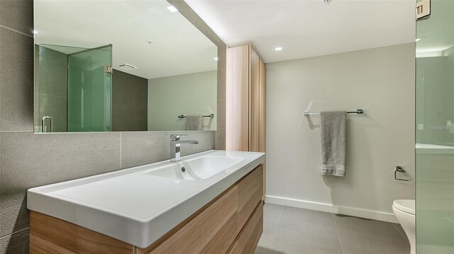 bathroom featuring tile patterned flooring, vanity, and toilet