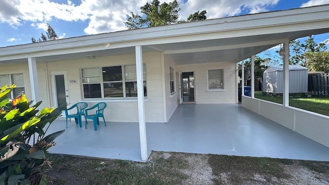 view of patio / terrace featuring a carport and a storage unit