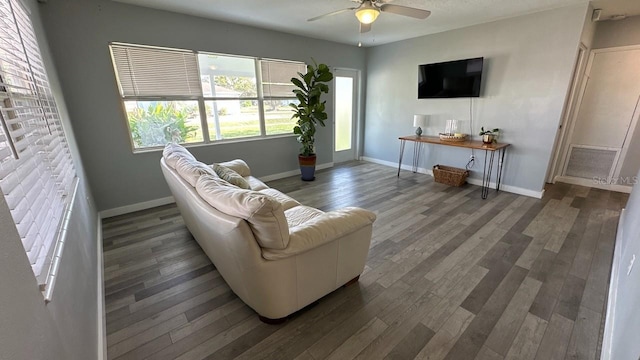 living room featuring dark hardwood / wood-style floors and ceiling fan