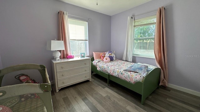 bedroom with dark hardwood / wood-style flooring