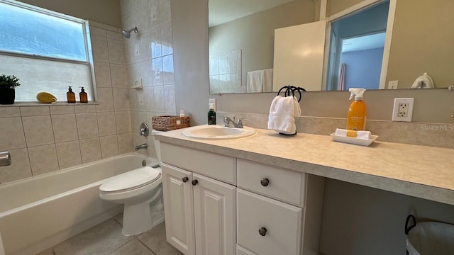 full bathroom featuring tile patterned floors, vanity, tiled shower / bath combo, and toilet