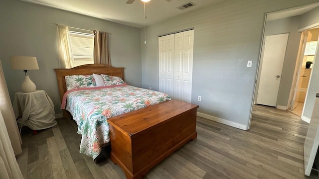 bedroom featuring hardwood / wood-style flooring, ceiling fan, and a closet