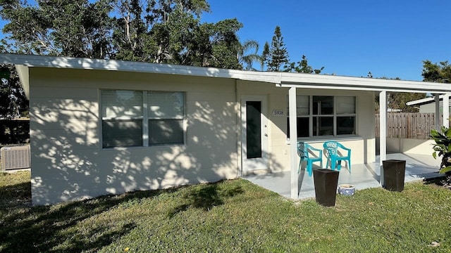 back of house featuring an outdoor structure, a yard, a patio, and central air condition unit