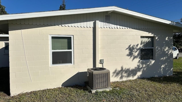 view of side of home with central air condition unit