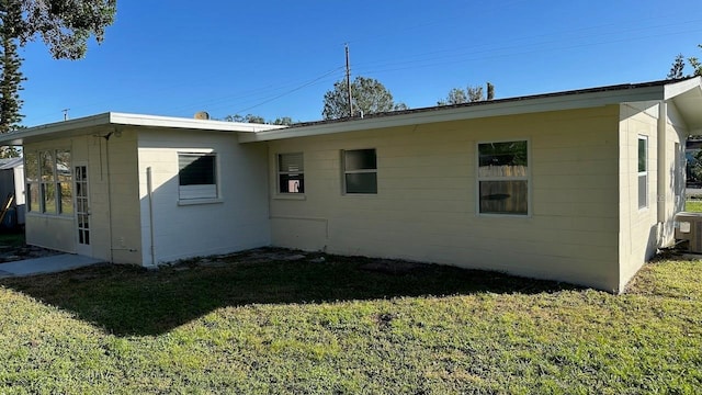 back of property featuring a yard