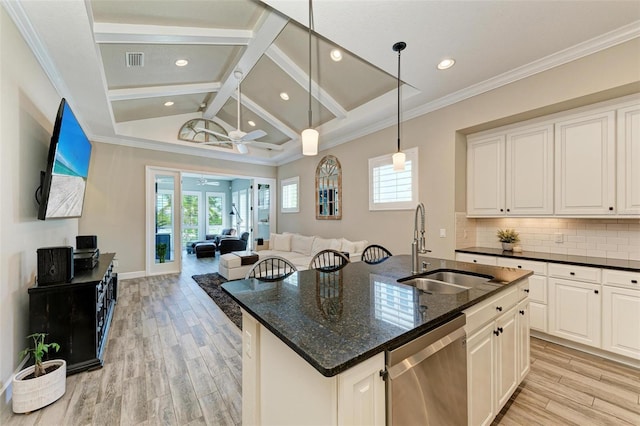 kitchen featuring white cabinetry, dishwasher, ceiling fan, dark stone counters, and a kitchen island with sink