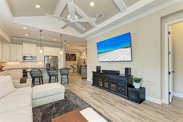 living room with vaulted ceiling with beams, ceiling fan, ornamental molding, and light wood-type flooring