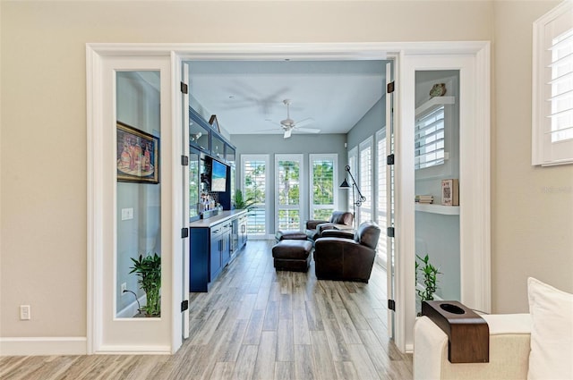 living room featuring light hardwood / wood-style flooring and ceiling fan