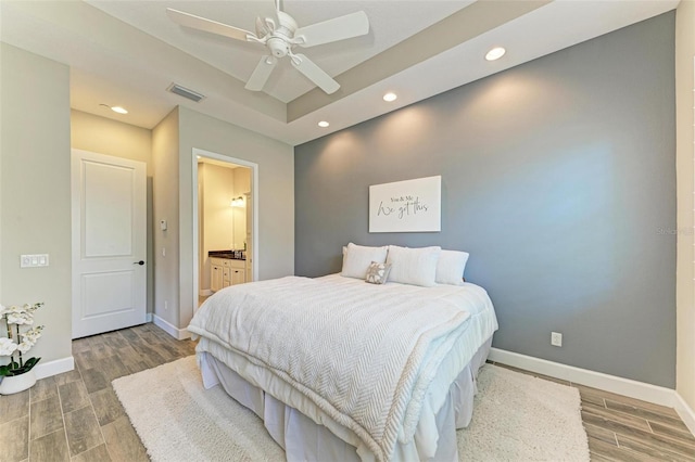 bedroom featuring ceiling fan and connected bathroom