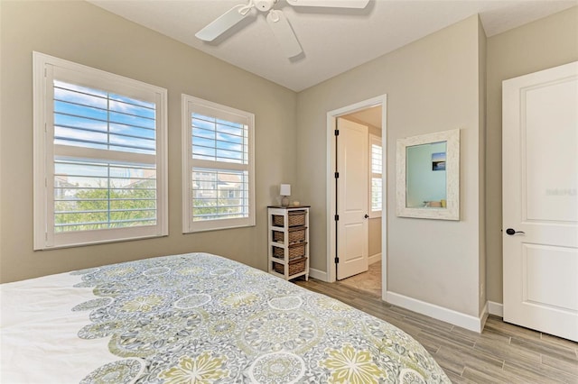 bedroom with light hardwood / wood-style floors and ceiling fan