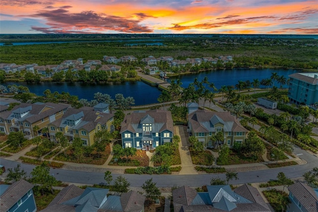 aerial view at dusk with a water view